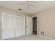 Neutral bedroom with closet space, standard ceiling fan, and natural lighting at 3262 Westcott Ct, Palm Harbor, FL 34684
