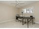 Bedroom area with a window providing natural light, a ceiling fan, and neutral carpet at 3262 Westcott Ct, Palm Harbor, FL 34684