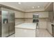 Spacious kitchen with stainless steel appliances, center island, and ample counter space at 3262 Westcott Ct, Palm Harbor, FL 34684