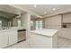 Bright kitchen featuring white cabinets, stainless appliances, and an island with sink at 3262 Westcott Ct, Palm Harbor, FL 34684