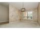 Living room featuring textured walls, neutral carpet, plantation shutters, and modern lighting at 3262 Westcott Ct, Palm Harbor, FL 34684