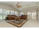 Expansive living room with vaulted ceilings, a brick fireplace, neutral carpet and two leather sofas at 3262 Westcott Ct, Palm Harbor, FL 34684
