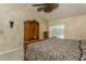 Cozy main bedroom features patterned wall-to-wall carpet, rustic decor, and a large wardrobe at 3262 Westcott Ct, Palm Harbor, FL 34684