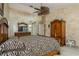 Spacious main bedroom features zebra-patterned bedding, neutral carpeting, and a rustic armoire at 3262 Westcott Ct, Palm Harbor, FL 34684