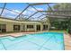 Relax in this screened-in pool with a sun shelf and patio for ultimate outdoor living at 3262 Westcott Ct, Palm Harbor, FL 34684