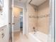Bathroom featuring tiled walls, shower over tub with tiled walls and neutral colors at 3312 Kenmore Dr, Sarasota, FL 34231