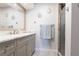 Well-lit bathroom featuring a glass shower, granite countertops, gray cabinets, and decorative towels at 3312 Kenmore Dr, Sarasota, FL 34231