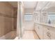 Bright bathroom with dual sinks, granite countertops and shower over tub combo at 3312 Kenmore Dr, Sarasota, FL 34231