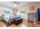 Cozy bedroom with a ceiling fan and a seaside theme and wood-look floors at 3312 Kenmore Dr, Sarasota, FL 34231