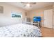 Tranquil bedroom features neutral tones, seaside decor, ceiling fan, TV, and natural light at 3312 Kenmore Dr, Sarasota, FL 34231