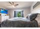 Inviting bedroom boasts a ceiling fan, plush bedding, bay window, and a mounted television at 3312 Kenmore Dr, Sarasota, FL 34231