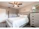 Cozy bedroom with ceiling fan, closet, and a matching dresser and bedside table at 3312 Kenmore Dr, Sarasota, FL 34231