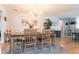 Bright dining room featuring a rustic wood table, chandelier, and artwork at 3312 Kenmore Dr, Sarasota, FL 34231