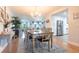 Open-concept dining room flows into a living area and kitchen, featuring a rustic table and decor at 3312 Kenmore Dr, Sarasota, FL 34231