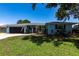 Charming one-story home with a two-car garage, manicured lawn, and lovely front yard landscaping at 3312 Kenmore Dr, Sarasota, FL 34231