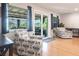Bright living room with hardwood floors, comfortable seating, and sliding glass doors to the lanai at 3312 Kenmore Dr, Sarasota, FL 34231