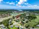 An aerial view showcases a beautiful neighborhood with mature landscaping, a serene pond, and easy access to the highway at 335 Palmdale Dr, Oldsmar, FL 34677
