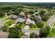 Aerial view of the home with mature landscaping, an in-ground pool, and a two-car driveway at 335 Palmdale Dr, Oldsmar, FL 34677