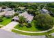 Expansive aerial view of a home with mature landscaping, a screened in lanai, and a two-car driveway at 335 Palmdale Dr, Oldsmar, FL 34677
