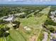 Enjoy a fantastic aerial view of the lush green golf course, complete with sand traps, ponds, and beautiful landscaping at 335 Palmdale Dr, Oldsmar, FL 34677