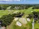 A captivating aerial view showcases the lush greens, sand traps, and serene ponds of this meticulously maintained golf course at 335 Palmdale Dr, Oldsmar, FL 34677