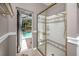Updated bathroom with glass-enclosed shower and access to a screened-in pool area, blending indoor and outdoor living at 335 Palmdale Dr, Oldsmar, FL 34677