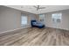 Expansive bedroom with laminate wood floors, three windows, and a small blue bed, offers versatile design options at 335 Palmdale Dr, Oldsmar, FL 34677