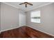 Neutral bedroom with hardwood floors, a ceiling fan, and a window with natural light, offering a comfortable space at 335 Palmdale Dr, Oldsmar, FL 34677
