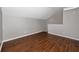 A well-lit bedroom features hardwood floors and neutral, light-grey colored walls at 335 Palmdale Dr, Oldsmar, FL 34677