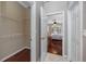 Walk-in closet with white wire shelving system and dark hardwood flooring in neutral colored room at 335 Palmdale Dr, Oldsmar, FL 34677