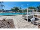 Relaxing poolside cabana and chairs overlooking the community swimming pool on a sunny day at 335 Palmdale Dr, Oldsmar, FL 34677