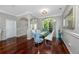 Dining room with arched doorways, hardwood floors, large windows, and seating for six at 335 Palmdale Dr, Oldsmar, FL 34677