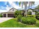 Beautiful single Gathering home with a well manicured yard, a two car garage, and mature landscaping in front at 335 Palmdale Dr, Oldsmar, FL 34677