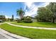 Well-maintained home featuring lush lawn, landscaping, and mature trees at 335 Palmdale Dr, Oldsmar, FL 34677