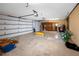 Spacious garage featuring an automatic door opener, storage, and painted concrete floor at 335 Palmdale Dr, Oldsmar, FL 34677