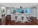 Stylish kitchen with light blue cabinets, a breakfast bar with seating, and dark hardwood floors at 335 Palmdale Dr, Oldsmar, FL 34677