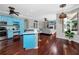 Modern eat-in kitchen with blue cabinets, hardwood floors and large island with seating at 335 Palmdale Dr, Oldsmar, FL 34677