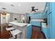 Bright kitchen featuring blue cabinets, stainless steel appliances, and a marble countertop breakfast bar with stool seating at 335 Palmdale Dr, Oldsmar, FL 34677