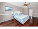 Spacious main bedroom with dark hardwood floors, ceiling fan and ensuite bathroom at 335 Palmdale Dr, Oldsmar, FL 34677