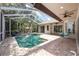 Outdoor pool in a screened enclosure, with ample space for seating and lounging at 335 Palmdale Dr, Oldsmar, FL 34677