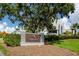 Ardea Country Club sign with beautiful landscaping and an elegant building in the background at 335 Palmdale Dr, Oldsmar, FL 34677