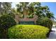 Woodlands Estates sign displayed amongst trees and manicured bushes at 335 Palmdale Dr, Oldsmar, FL 34677