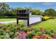East Lake Woodlands sign surrounded by colorful flowers and lush landscaping at 335 Palmdale Dr, Oldsmar, FL 34677