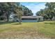 Sprawling backyard with mature trees and screened in porch at 3440 Pittman Rd, Dover, FL 33527
