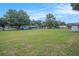 Expansive backyard, showcasing a verdant lawn, mature trees and additional outbuilding at 3440 Pittman Rd, Dover, FL 33527