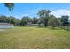 Spacious backyard, fenced in, with mature trees and additional outbuilding at 3440 Pittman Rd, Dover, FL 33527