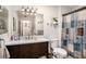 Bright bathroom with a modern vanity, framed mirror, and a shower/tub combo at 3440 Pittman Rd, Dover, FL 33527