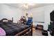 Cozy bedroom with a wooden bed frame, ceiling fan, and natural light at 3440 Pittman Rd, Dover, FL 33527