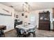 Cozy dining area featuring wood-look floors, a modern chandelier, and direct backyard access at 3440 Pittman Rd, Dover, FL 33527