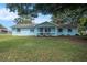 Charming, light blue single-story home with well-maintained lawn and cozy front porch at 3440 Pittman Rd, Dover, FL 33527